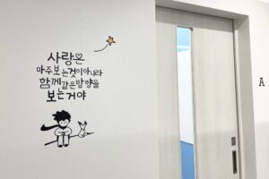 K Village博多駅前校のウォールステッカーが貼られた廊下の壁を写した写真